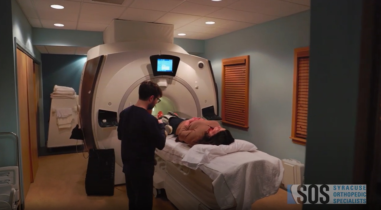 mri tech jobs near syracuse ny mri technologist and patient with mri machine sos syracuse orthopedic specialists logo
