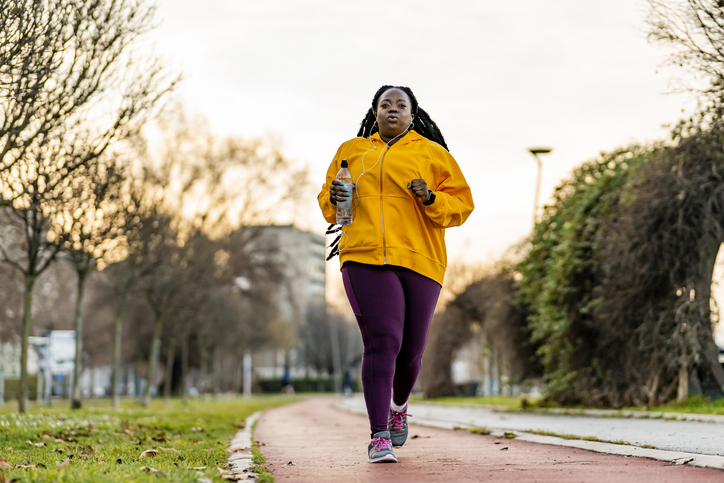 Plus size woman running in the park