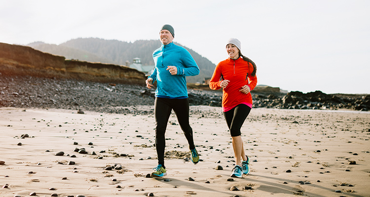 foot and ankle doctors near watertown ny image of man and woman jogging on beach