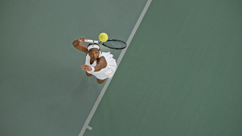 Female tennis player overhead shot serving ball