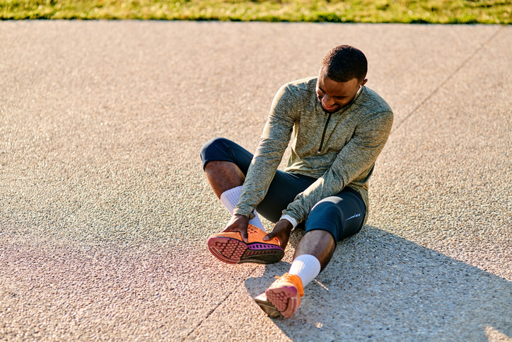 Runner holding foot in pain