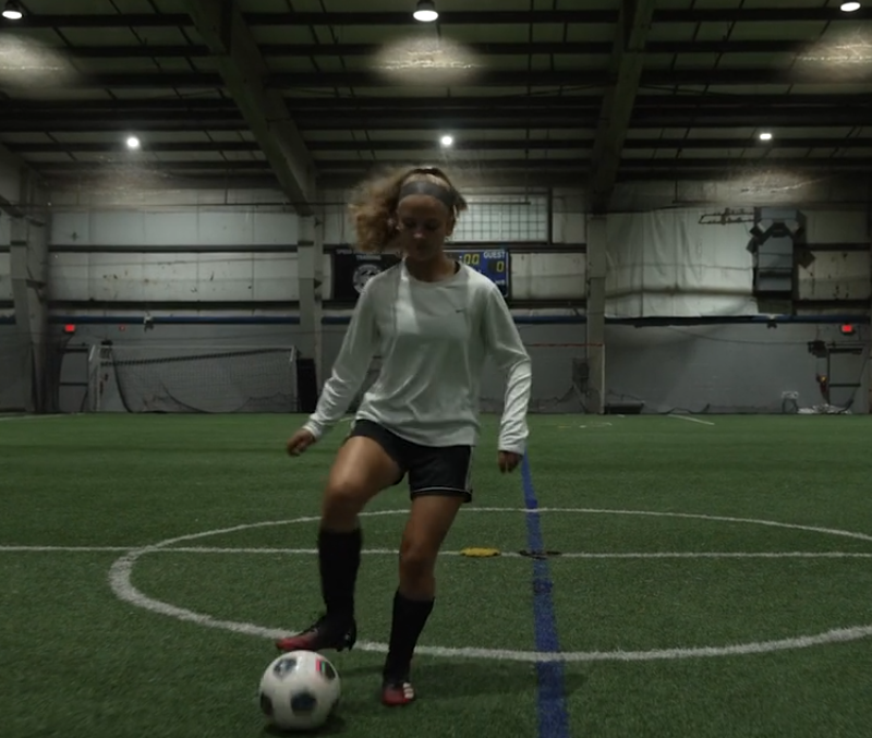 High School Female Athlete Dribbling Soccer Ball in Syracuse, NY Sports Center